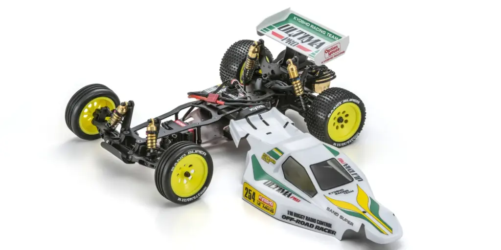Kyosho Ultima Pro Vintage Series 1:10 2WD racing buggy kit, chassis alongside its white, green and yellow bodyshell