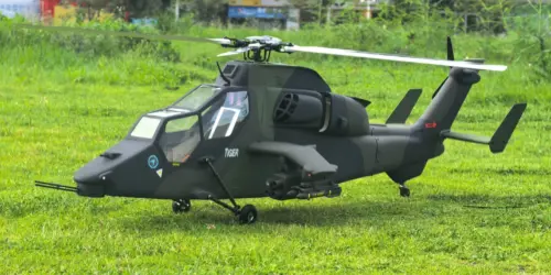 FLISHRC Tiger 700-size scale RC helicopter in green and black camouflage, side profile on grass