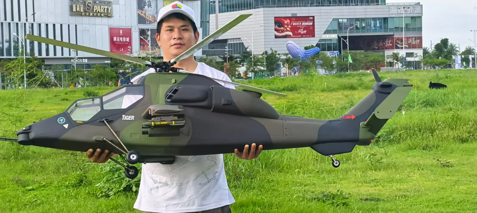 FLISHRC Tiger 700-size scale RC helicopter held at arm span, showing the size of the airframe