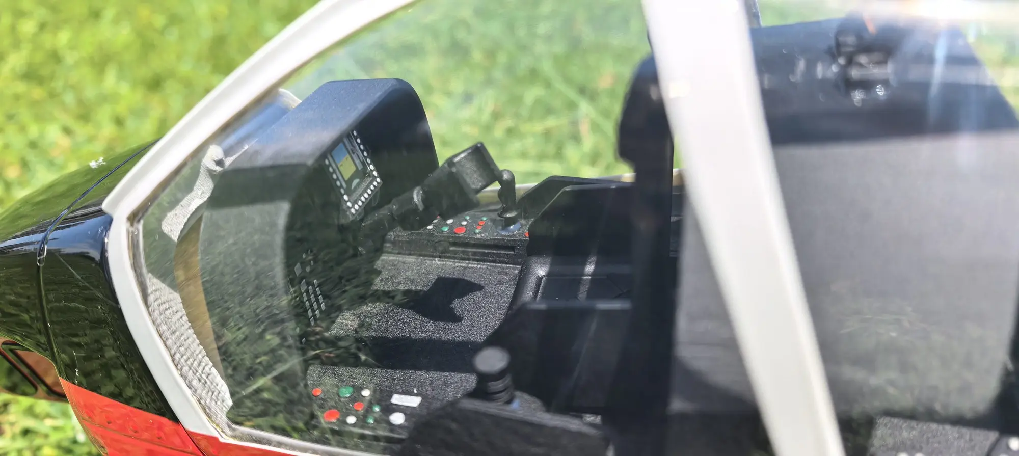 Detailed pilot cockpit and instrument panel inside the FLISHRC AH-1 Cobra scale RC helicopter canopy