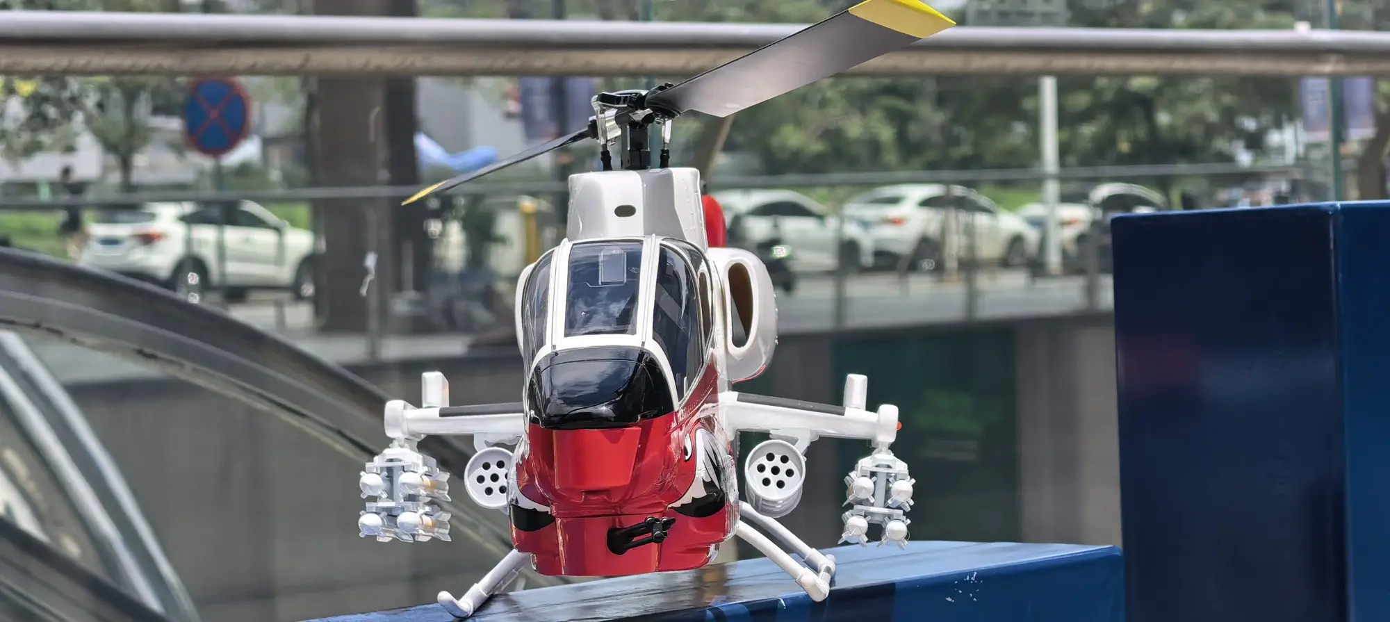 Head-on view of the FLISHRC AH-1 Cobra white and red RC helicopter showing the scale canopy and skids