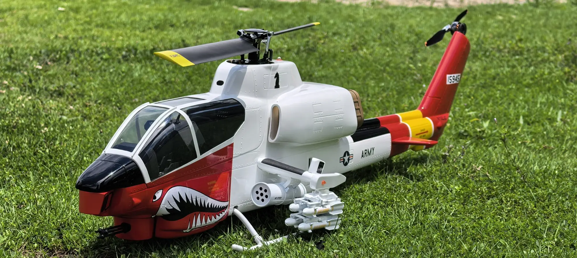 Nose-on view of the FLISHRC AH-1 Cobra white and red RC helicopter showing the tandem cockpit and chin turret